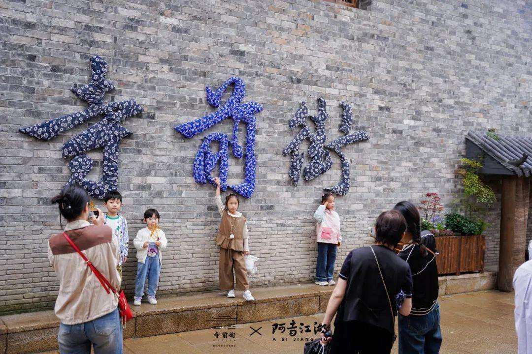 江湖庭院墙上“寺前街”三个大字,由中华传统印染技艺组成.jfif